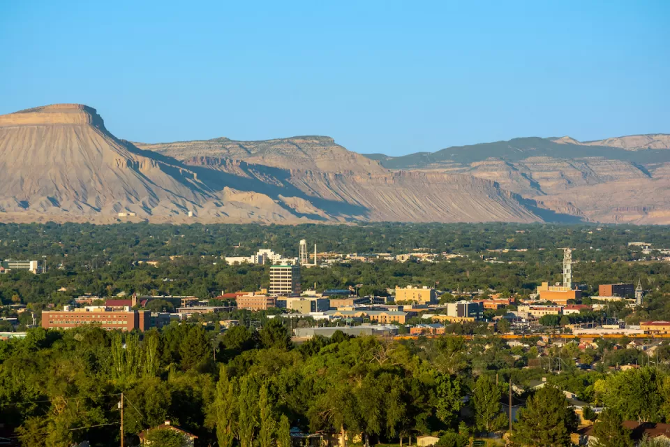 View of downtown Grand Junction, Colorado with mesas in background.